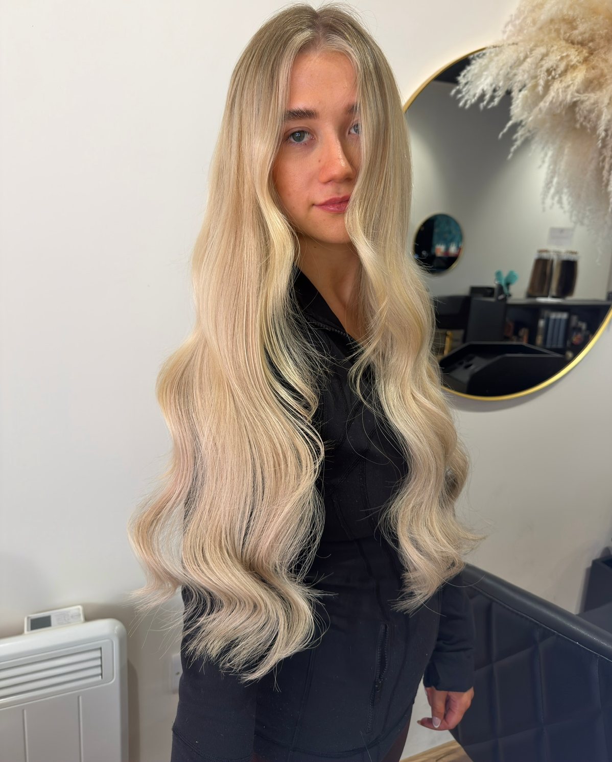 Long blonde hair extensions with soft waves at ELM Hair and Beauty, Wrexham