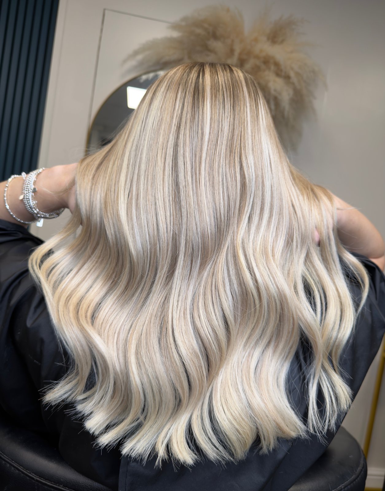 Bright blonde full head highlights styled in waves at ELM Hair and Beauty, Wrexham