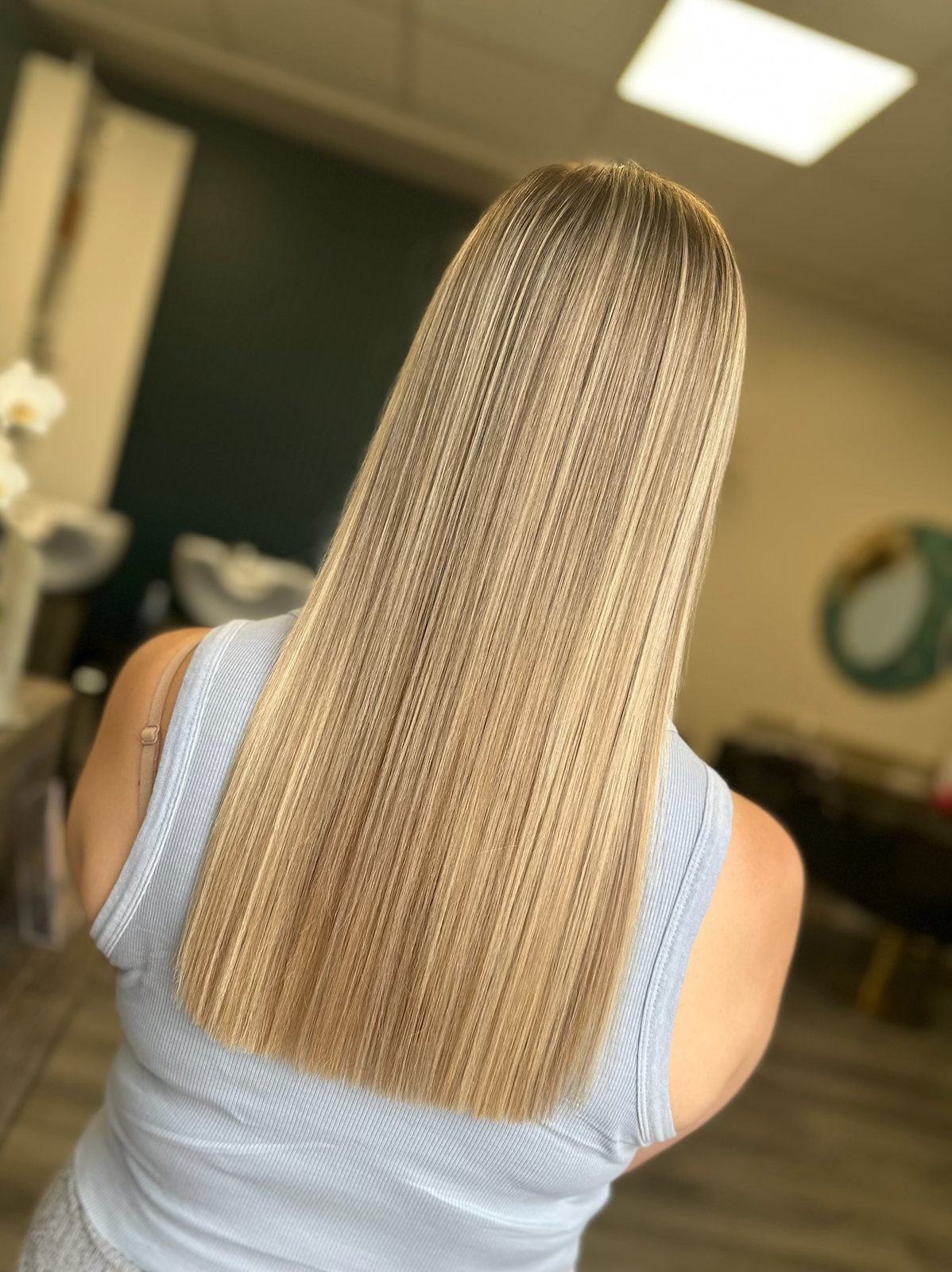 Long blonde hair with a sleek blow dry at ELM Hair and Beauty, Wrexham