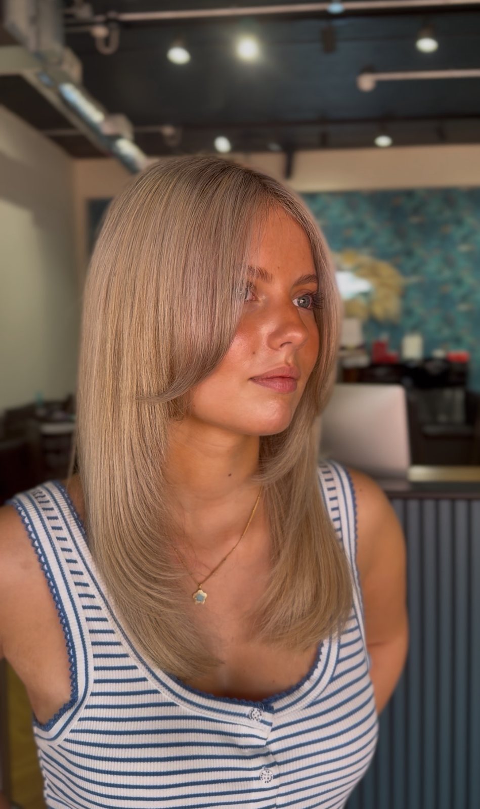 Long layered haircut with a curtain fringe at ELM Hair and Beauty, Wrexham