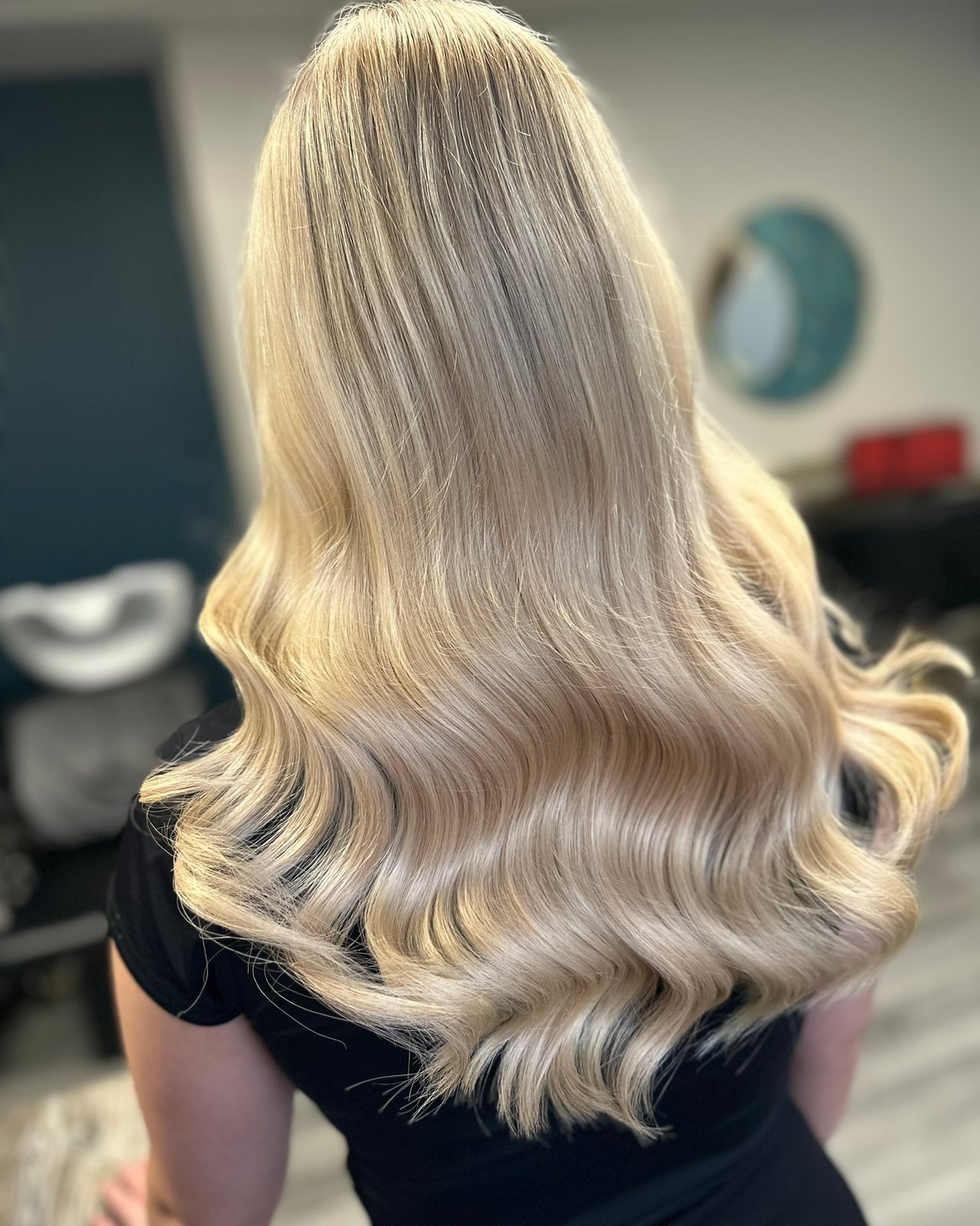 Platinum blonde highlights on long waves at ELM Hair and Beauty, Wrexham