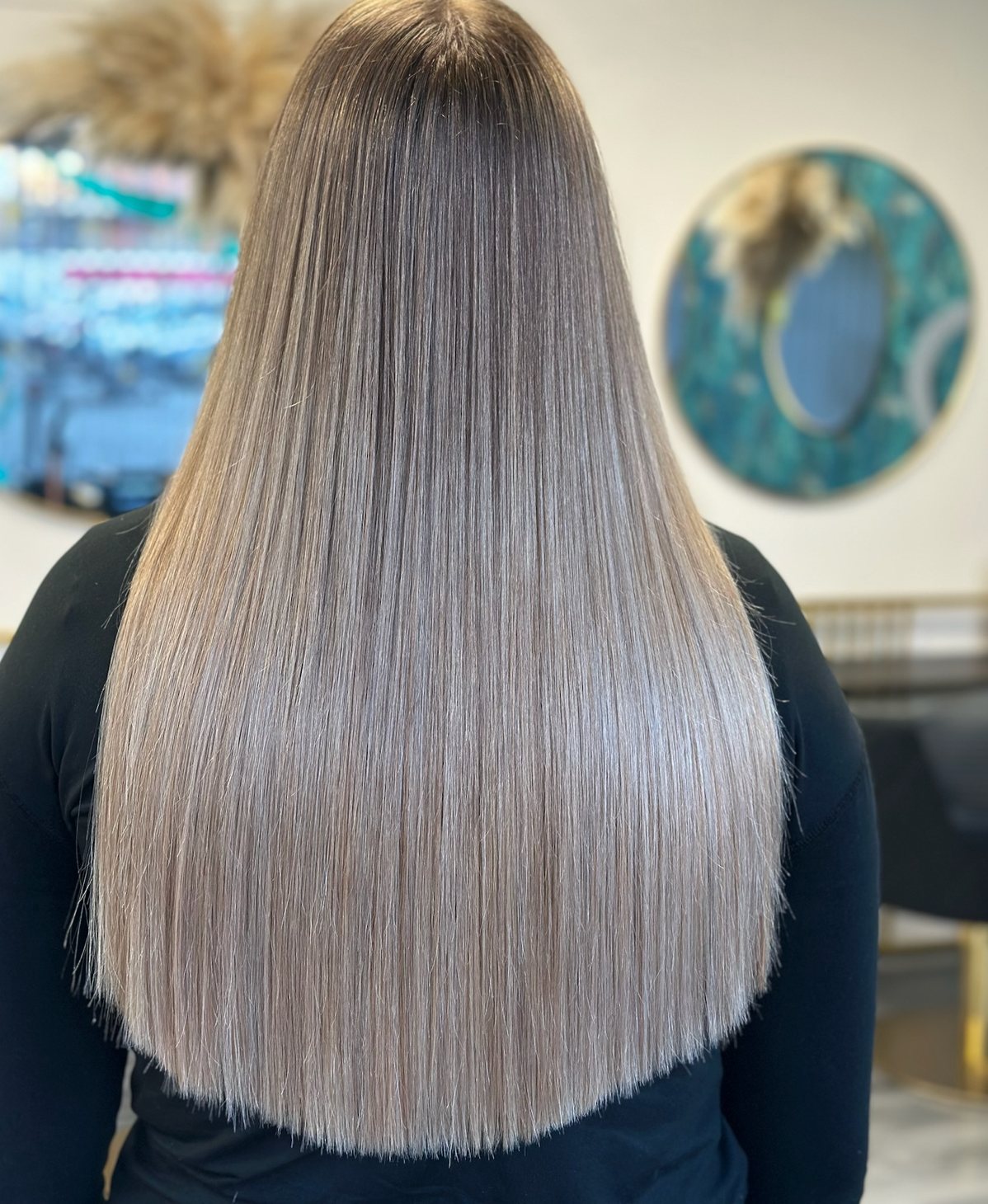 Sleek long haircut with a smooth blow dry at ELM Hair and Beauty in Wrexham